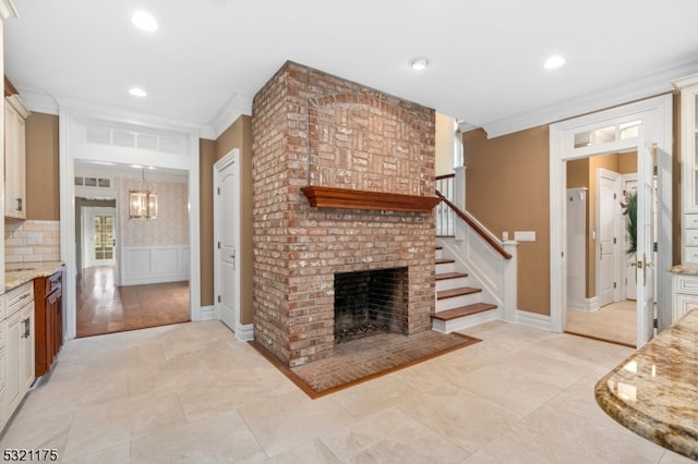 living room with a fireplace and ornamental molding