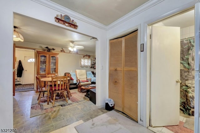 dining space featuring ceiling fan and ornamental molding