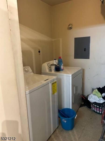 laundry room featuring washer and dryer, electric panel, and light tile patterned floors