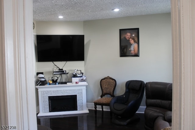 living room featuring a fireplace and a textured ceiling