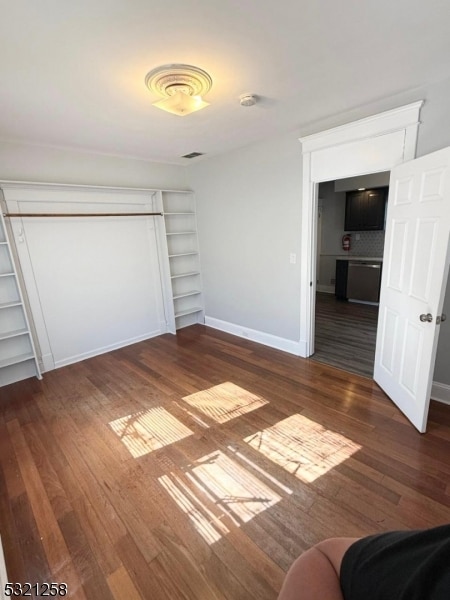 unfurnished bedroom featuring dark wood-type flooring