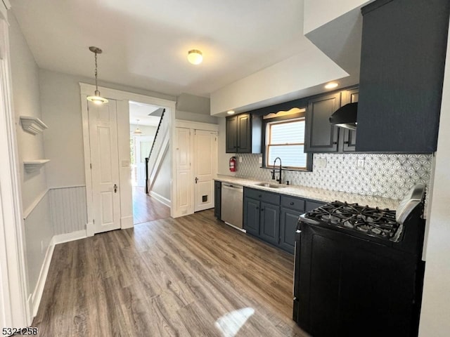 kitchen featuring decorative backsplash, hardwood / wood-style floors, black gas range, stainless steel dishwasher, and sink