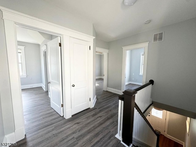 hallway with dark hardwood / wood-style flooring