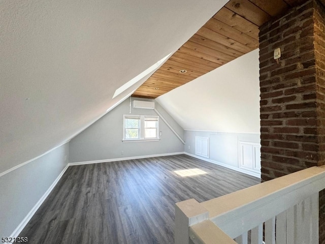 bonus room with dark wood-type flooring, a wall mounted AC, vaulted ceiling with skylight, and wooden ceiling