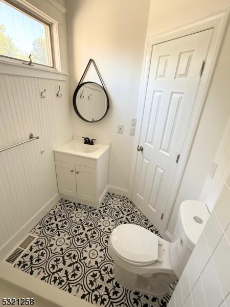 bathroom featuring vanity, toilet, and tile patterned floors