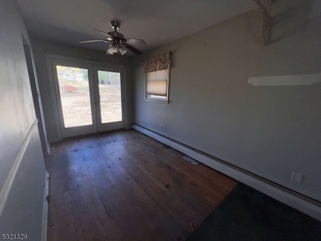 spare room with hardwood / wood-style floors, baseboard heating, french doors, and ceiling fan