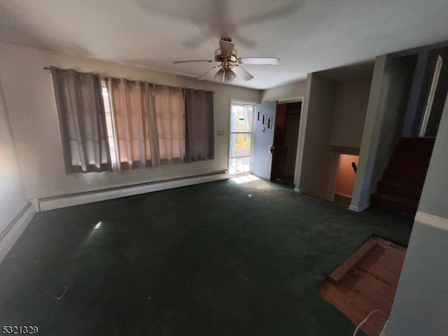 unfurnished living room featuring dark colored carpet, a baseboard radiator, and ceiling fan