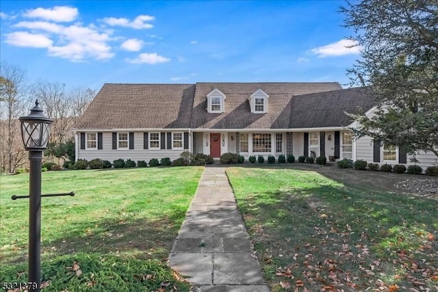 new england style home featuring a front lawn