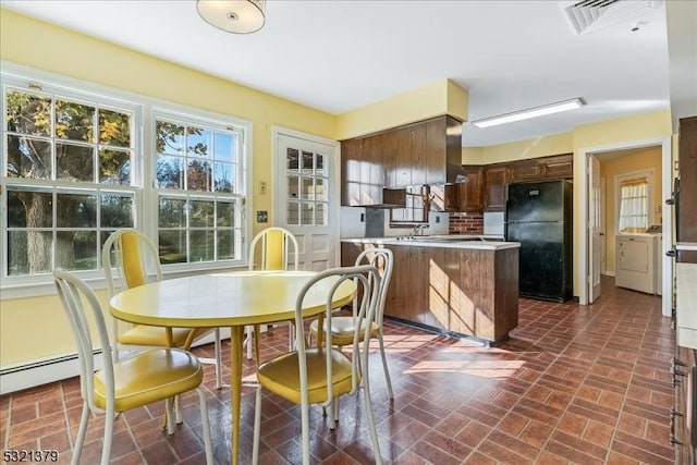 dining area with washer / dryer and a baseboard radiator