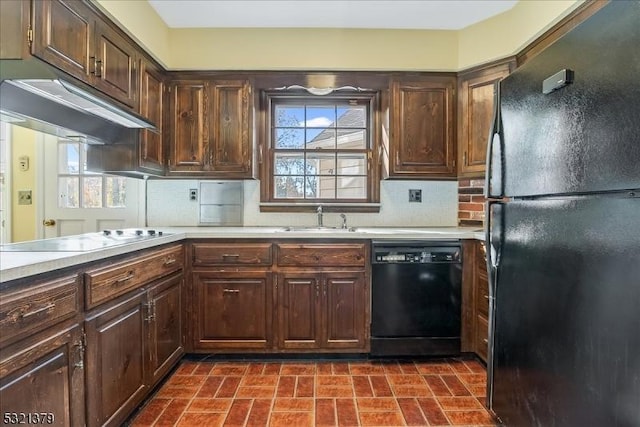 kitchen with black appliances, backsplash, sink, and dark brown cabinetry