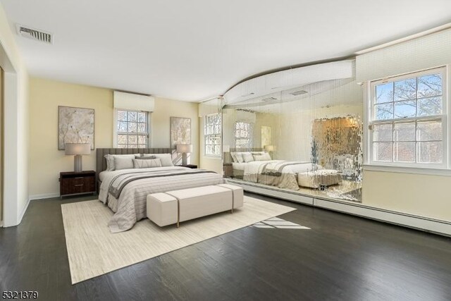 bedroom featuring multiple windows and hardwood / wood-style floors