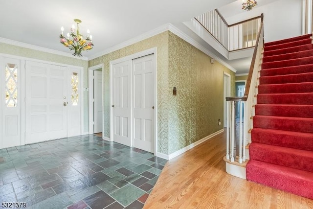 foyer featuring a chandelier and ornamental molding