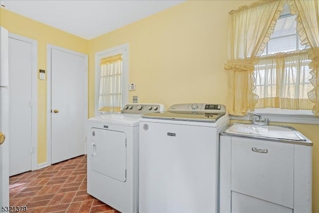 laundry room with washer and dryer and sink