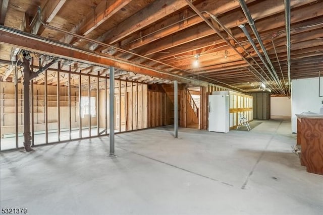 basement with white fridge