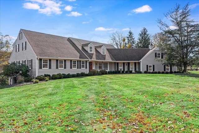 cape cod home with a front lawn