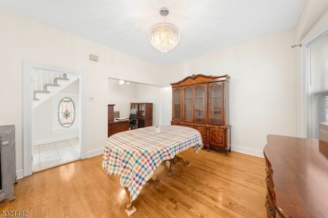 bedroom featuring light hardwood / wood-style floors and an inviting chandelier