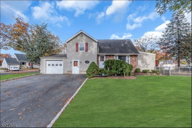 view of front of property featuring a front lawn and a garage