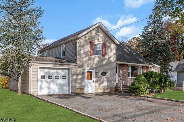 view of front of property with a front yard and a garage