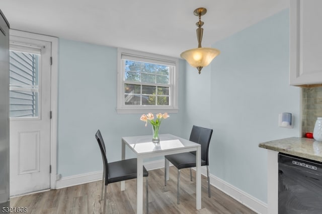 dining space with light wood-type flooring