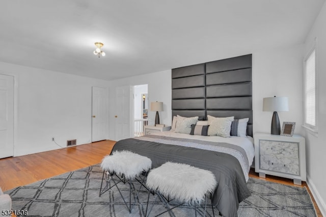 bedroom with hardwood / wood-style flooring