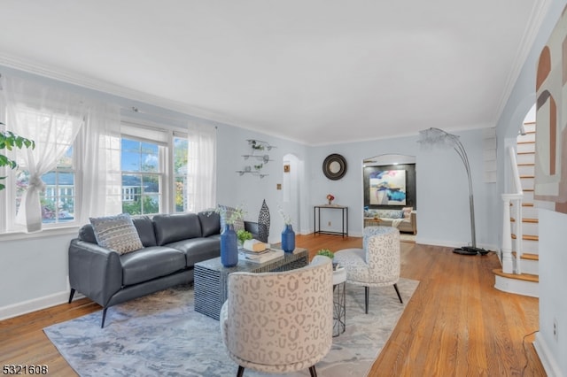 living room with ornamental molding and hardwood / wood-style flooring