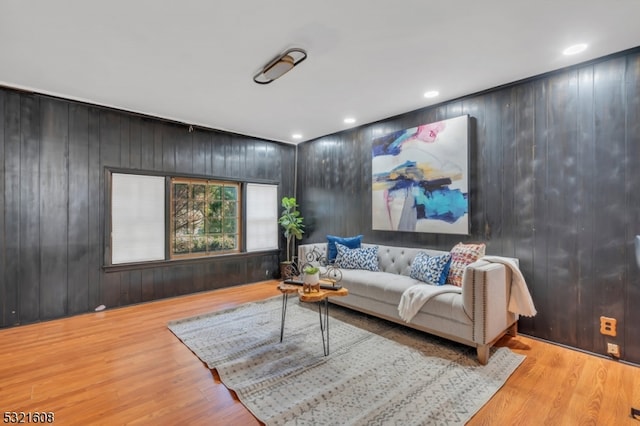 living room with wooden walls and light wood-type flooring