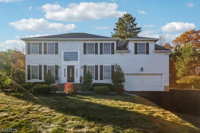 view of front of house with a garage and a front yard