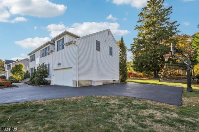 view of side of property with a yard and a garage