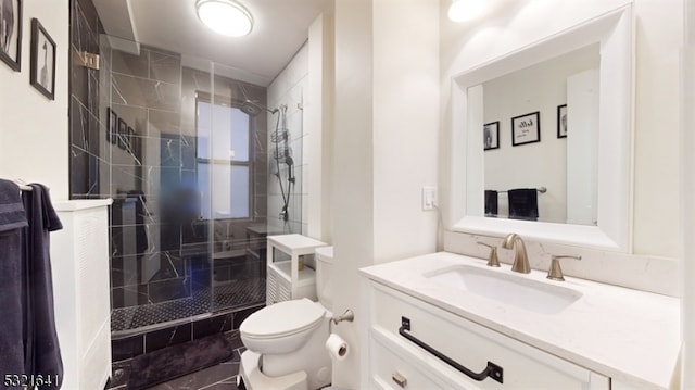 bathroom with tile patterned flooring, a shower with door, vanity, and toilet