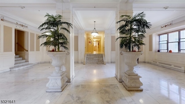 corridor with ornamental molding and baseboard heating