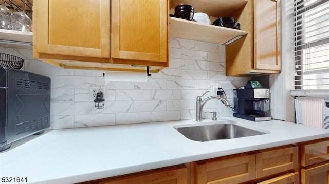 kitchen featuring sink and tasteful backsplash