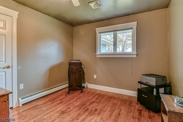 miscellaneous room with baseboard heating, light hardwood / wood-style flooring, and ceiling fan