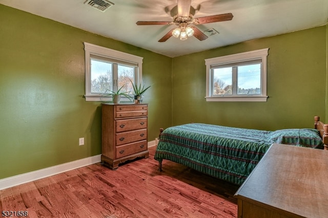 bedroom with hardwood / wood-style floors and ceiling fan