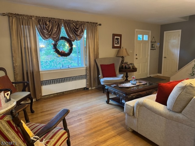 living room with light hardwood / wood-style flooring and radiator