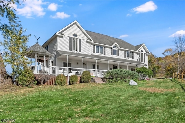 view of front of house with covered porch and a front lawn