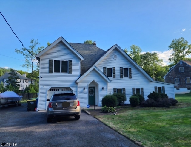 view of front of home featuring a garage and a front yard