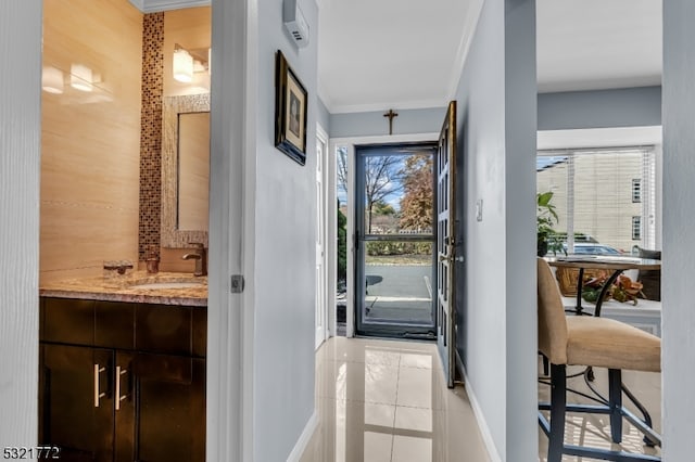 entryway with ornamental molding and sink