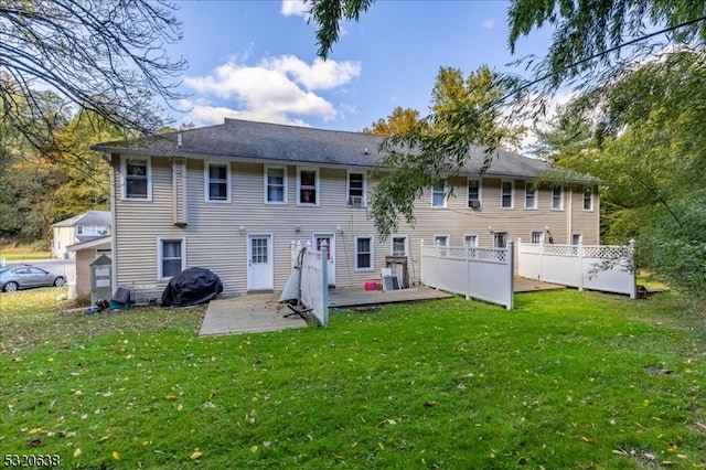 back of property with a yard and a patio area