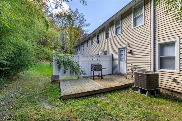 back of property featuring a wooden deck and cooling unit