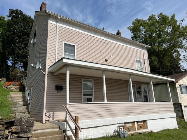 back of property featuring a porch