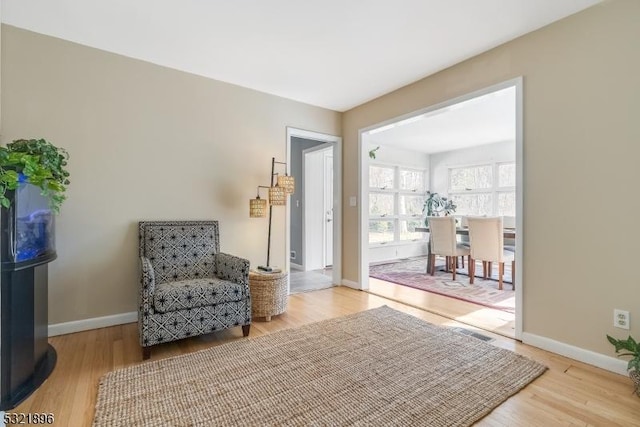 sitting room with wood finished floors and baseboards