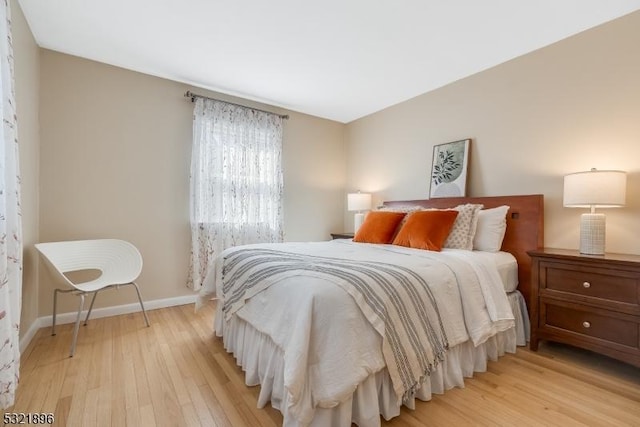 bedroom with baseboards and light wood-style floors