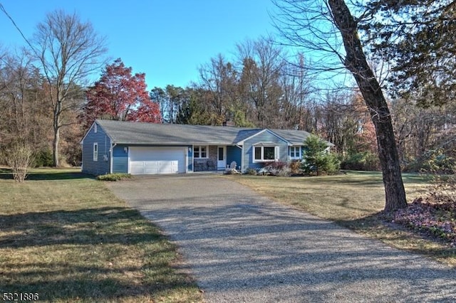 single story home with an attached garage, driveway, a chimney, and a front lawn