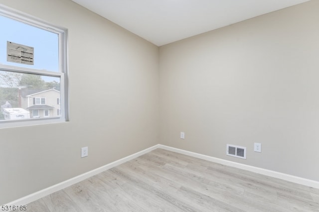 spare room with light hardwood / wood-style flooring