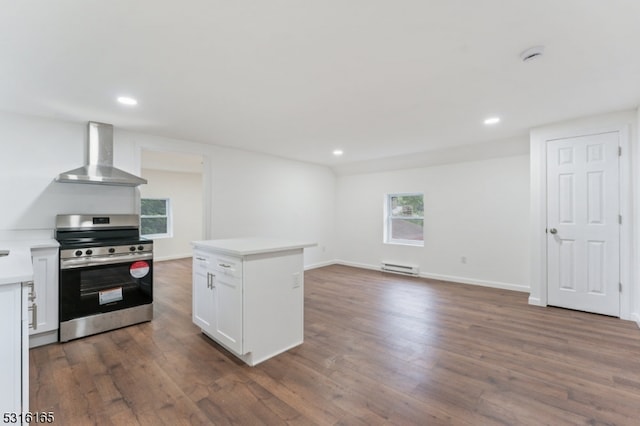 kitchen with a center island, white cabinetry, wall chimney exhaust hood, stainless steel range, and dark wood-type flooring