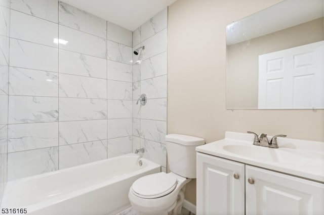 full bathroom featuring vanity, tiled shower / bath, and toilet