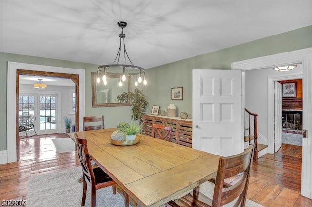 dining area with light hardwood / wood-style floors and french doors