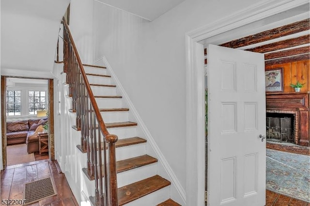 stairway with a brick fireplace