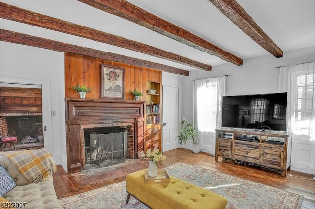 living room with beamed ceiling and hardwood / wood-style floors