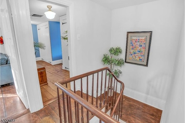 stairway with hardwood / wood-style flooring